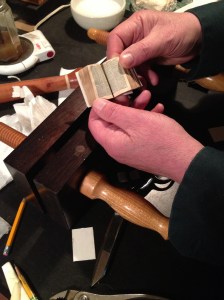 Tom Conroy holds a small bible - for scale